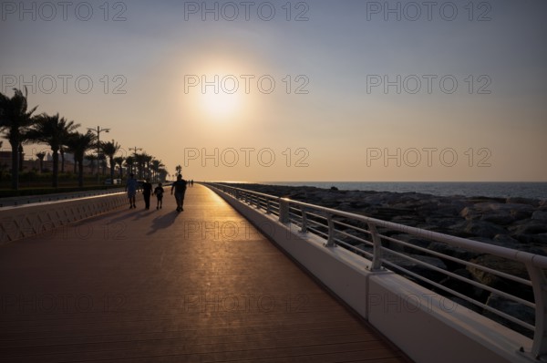 Sunset, walker, The Boardwalk, waterfront promenade, Palm Jumeirah, Dubai, United Arab Emirates,
