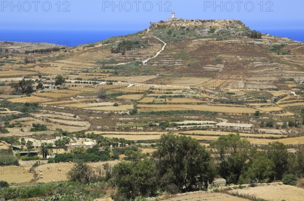 Rural landscape view from Zebbug to hilltop Ta 'Gurdan, Gordan or Gordon lighthouse, Gozo, Malta,