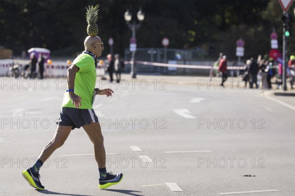 Pineapple Marathon Runner (Moshe Lederfien) balances a pineapple on his head during the run at the