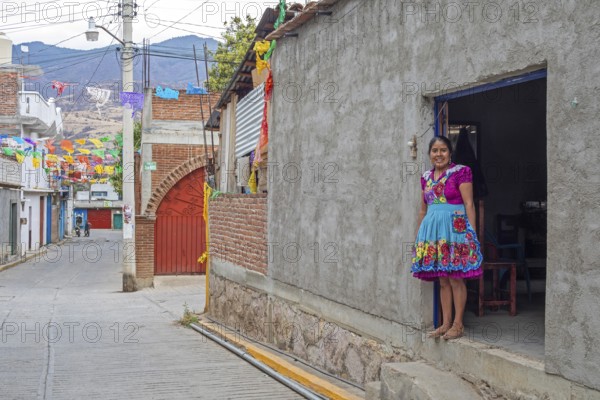 San Miguel del Valle, Oaxaca, Mexico, Epifania Hernandez Garcia stands in the doorway of her shop,