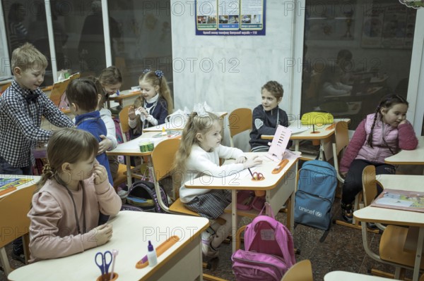 Pupils in a classroom in one of the metro schools in Kharkiv. Classrooms were set up in various