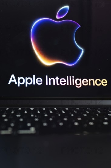 Apple logo in bright neon colours on a Macbook with illuminated keyboard and the text 'Apple