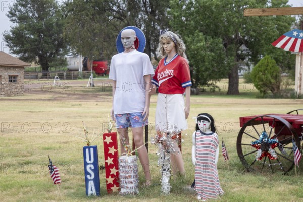 Laverne, Oklahoma, A patriotic family is part of a display in front of a rural Oklahoma home