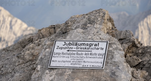 Signpost for difficult mountain tour, signpost Jubiläumsgrat in the evening light, steep rocky