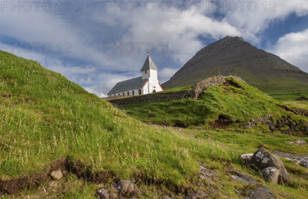 Church in front of a mountain backdrop, Malinsfjall mountain, Vidareidi, Vidoy island, Viðareiði,