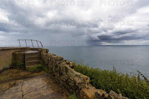 Rain clouds over the sea, coastline between Ballycastle and Ballintoy, viewpoint, Causeway Coastal