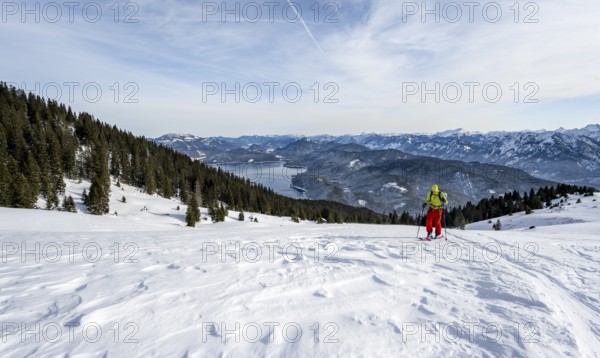 Ski tourers climbing Simetsberg, view of Walchensee, Estergebirge, Bavarian Prealps, Bavaria