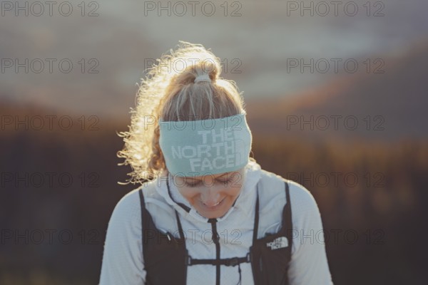 Trail running in autumn on the Jochberg on Lake Walchensee against the wonderful backdrop of the