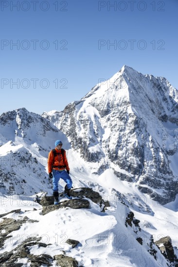 Ski tourers on foot, mountain panorama with snow-covered mountain landscape in winter, view of