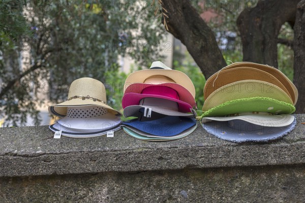 Sun hats on a wall for sale, Genoa, Italy, Europe