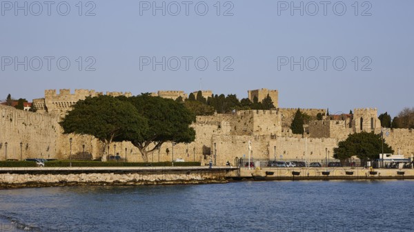 The fortress walls on the coast form a peaceful retreat next to the clear water, Outer city walls,