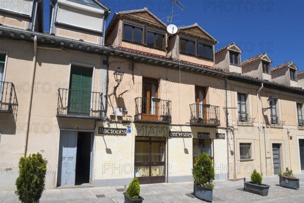 Sunny street scene with buildings, balconies and signs in a Spanish town, Calle de Jose Costa, San