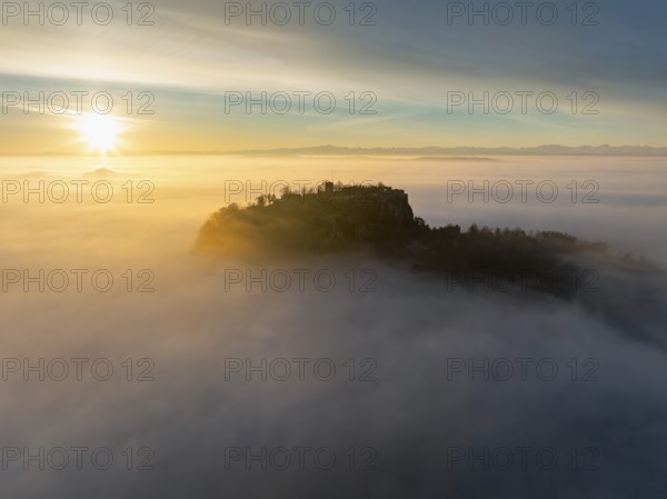 Aerial view of the Hegau volcano Hohentwiel with the upper fortress ruins as a silhouette at