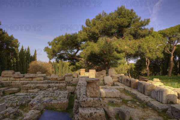 HDR Photo, Remains of Athena Polias Temple, Ancient ruins of stone, surrounded by trees, under blue