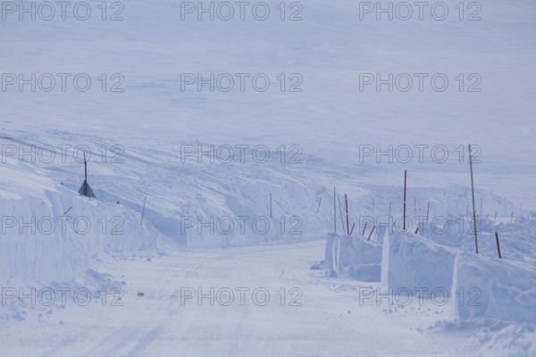 Snow-covered road, snow drifts, winding, winter, Finnmark, Norway, Europe