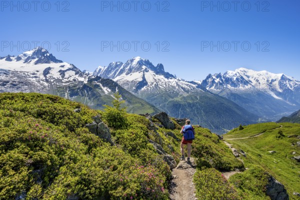 Mountaineer on hiking trail, mountain panorama with glaciated mountain peaks, Aiguille Verte with