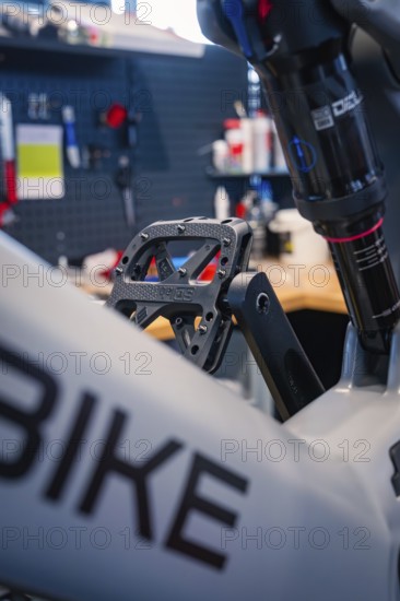 Close-up of a bicycle pedal and frame in a modern workshop, Waldbike Manufaktur, bicycle workshop,