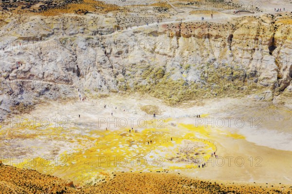 People walking around Stefanos crater moonlike landscape, Nisyros Island, Dodecanese Islands,