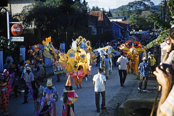 People in colourful costumes at the carnival parade, Port of Spain, Trinidad 1963 with the title