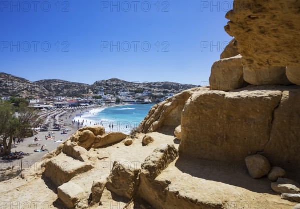 View from the rock caves to the beach of Matala, south coast, Crete, Greece, Europe