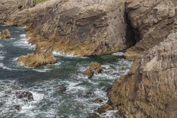Rocky west coast of the Quiberon peninsula in Brittany, France. Crashing waves and rocks