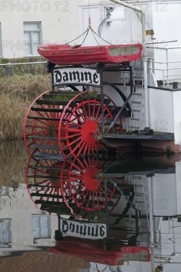Red paddle wheel and red lifeboat, nostalgic paddle steamer Lamme Goedzack on the canal from Damme