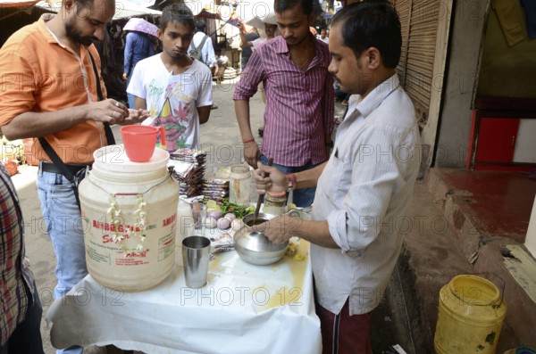 Man churning lassi, Kolkata, West Bengal, India, Asia