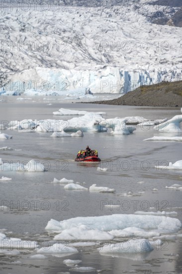 Boats with tourists in the glacier lagoon, ice lagoon Fjallsárlón, ice floes in front of glacier