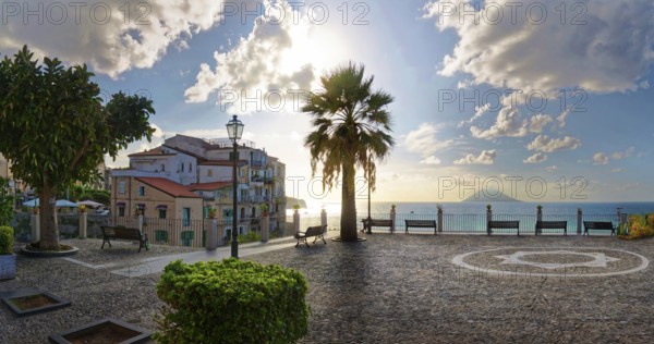 Belvedere Piazza del Cannone town square with the sun at its lowest and the Stromboli volcano in
