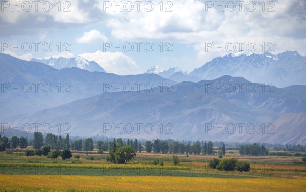 View over fields in the Chüi valley and the mountains of the Kirghiz Ala Too range, near Tokmok,
