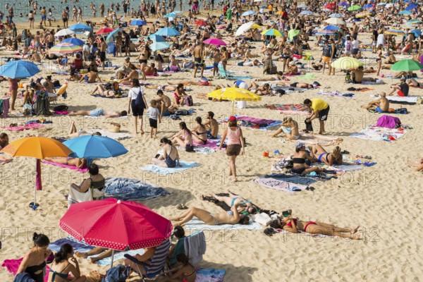 Crowded beach with people in August, San Sebastian, Donostia, Basque Country, Northern Spain,