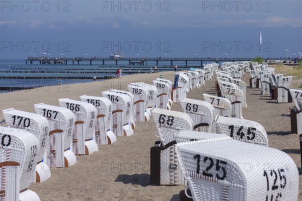 White beach chairs with pier on the beach of Heiligendamm, Mecklenburg-Western Pomerania, Germany,