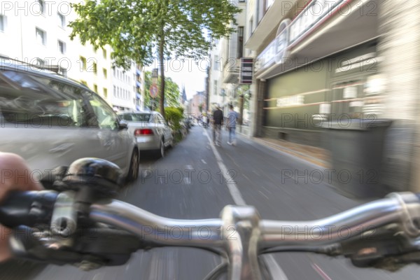 Cycling from a first-person perspective on a cycle path in Cologne, North Rhine-Westphalia,