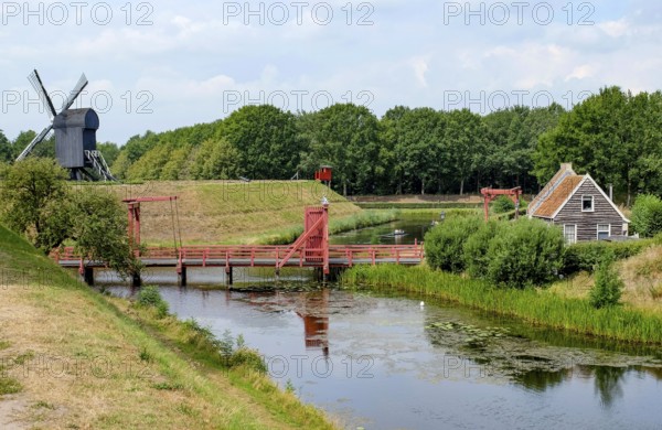 Bourtange Fortress, drawbridge over fortress moat, trestle windmill, Groningen Province,