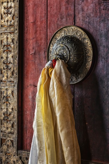 Decorated door handle of gates of Thiksey gompa (Tibetan Buddhist monastery) . Ladakh, India, Asia