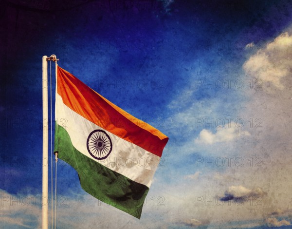 Vintage retro effect filtered hipster style image of India indian flag against blue sky with