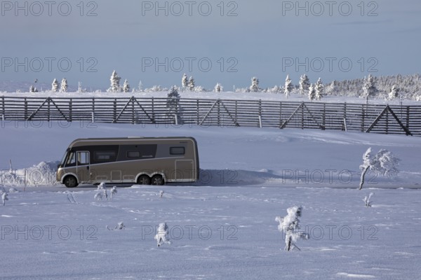 Winter camping with camper van on a mountain near Saariselkä, Lapland, Finland, Europe