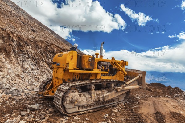 LADAKH, INDIA, SEPTEMBER 12, 2011: Bulldozer doing road constractuion on Kardung La pass in