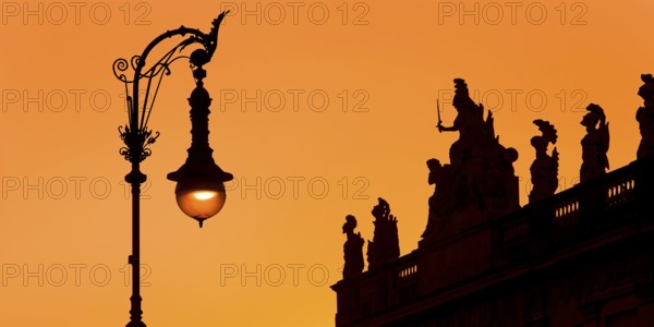 Old Berlin gas lantern in the street Unter den Linden at sunset at the German Historical Museum,