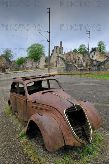 Burnt-out Peugeot 202 of family doctor Desourteux on the street The burnt-out village of