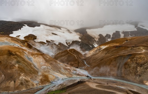Bridge and steaming streams between colourful rhyolite mountains and snowfields, Hveradalir