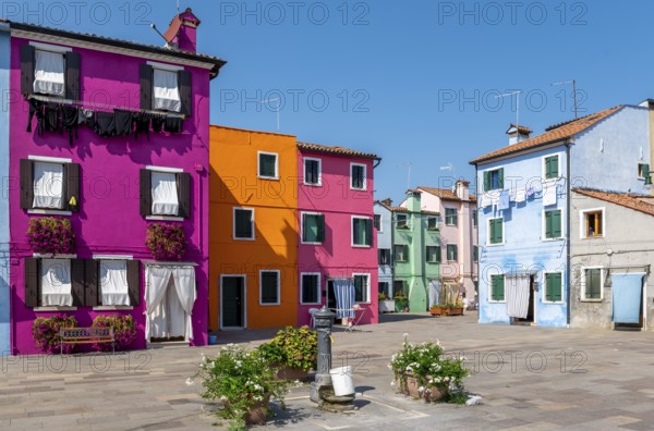 Colourful houses with washing lines and flowers, colourful house facades, alleyways on the island