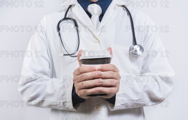 Hands of doctor holding takeaway coffee on isolated background. Doctor hands holding paper coffee
