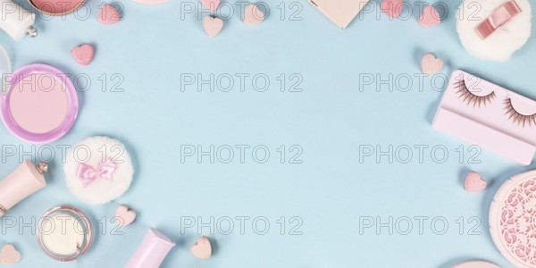 Banner with cute pink makeup beauty products like brushes, powder or lipstick on sides of pastel