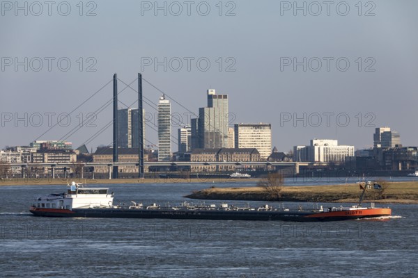 Düsseldorf, city centre skyline, skyscrapers, Rheinkniebrücke, Rhine, cargo ship