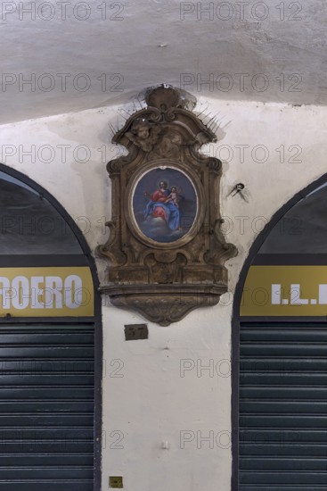 Marian picture with decorative frame in the old arcades at the harbour, Genoa, Italy, Europe