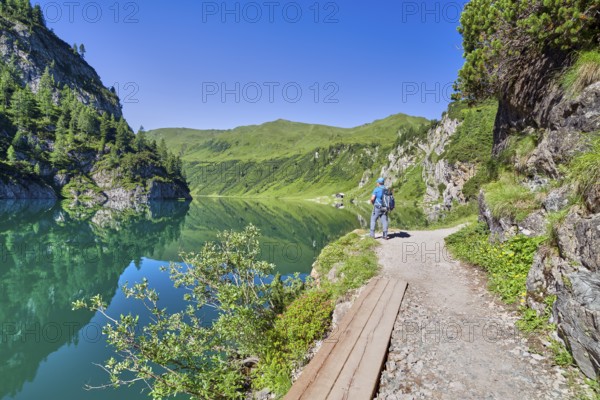 Hikers at Tappenkarsee, reflection, mountain lake, Radstätter Tauern, landscape conservation area,