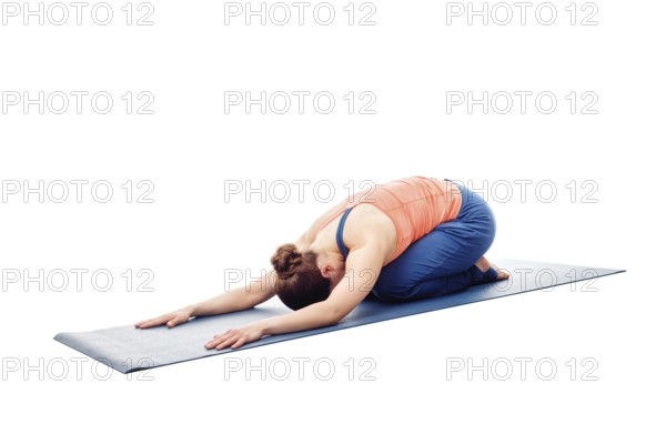 Woman doing Ashtanga Vinyasa Yoga relaxation asana Balasana, child posture, resting pose or counter