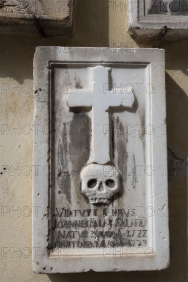 Gravestone with cross and skull, spa town of Merano, South Tyrol, Italy, Europe