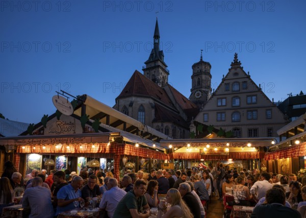 People sitting in wine arbours in the evening, Weindorf Stuttgart, Schillerplatz, collegiate